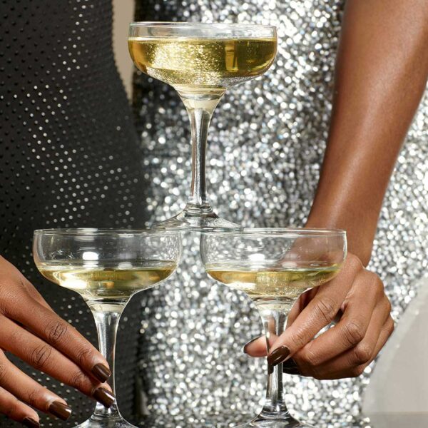 women in sparkly party clothes holding glasses of champagne