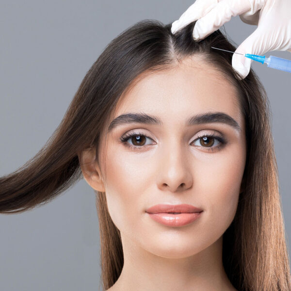 Woman having injection treatment for hair loss