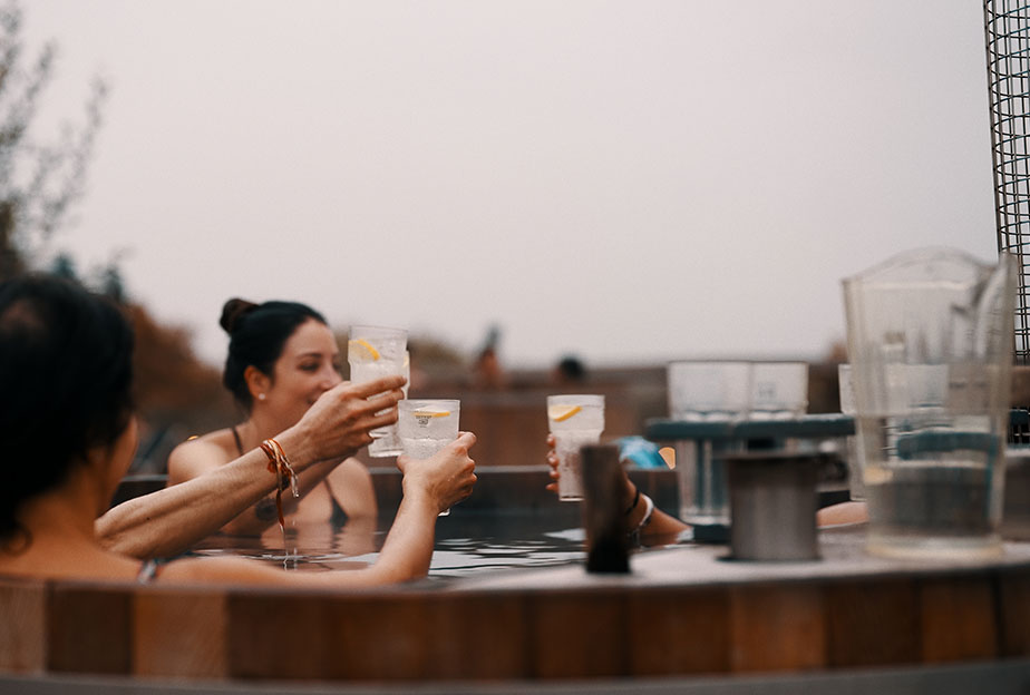 people drinking in a hot tub