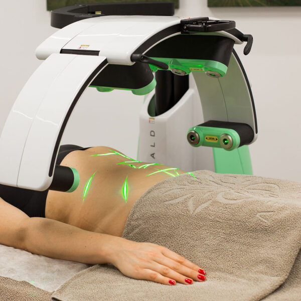 Woman lying down under a machine having laser treatment